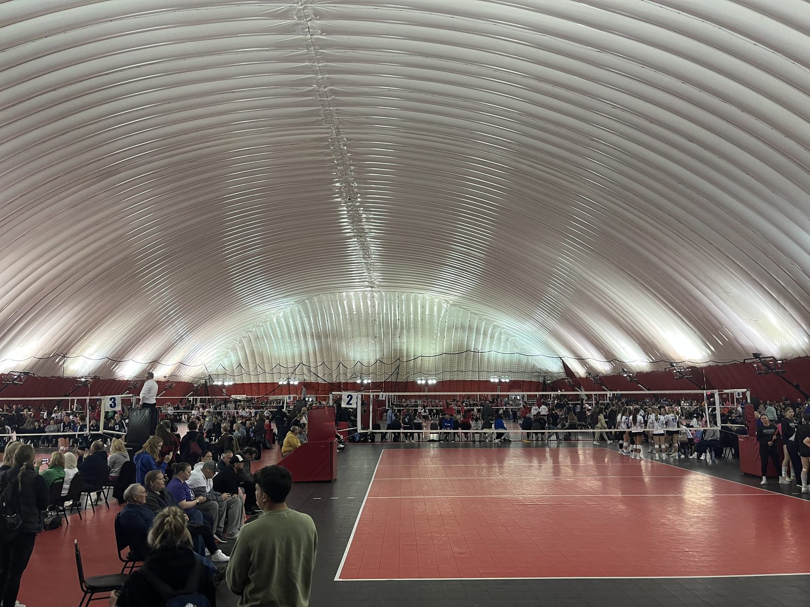 Volleyball tournament courts inside a large indoor venue