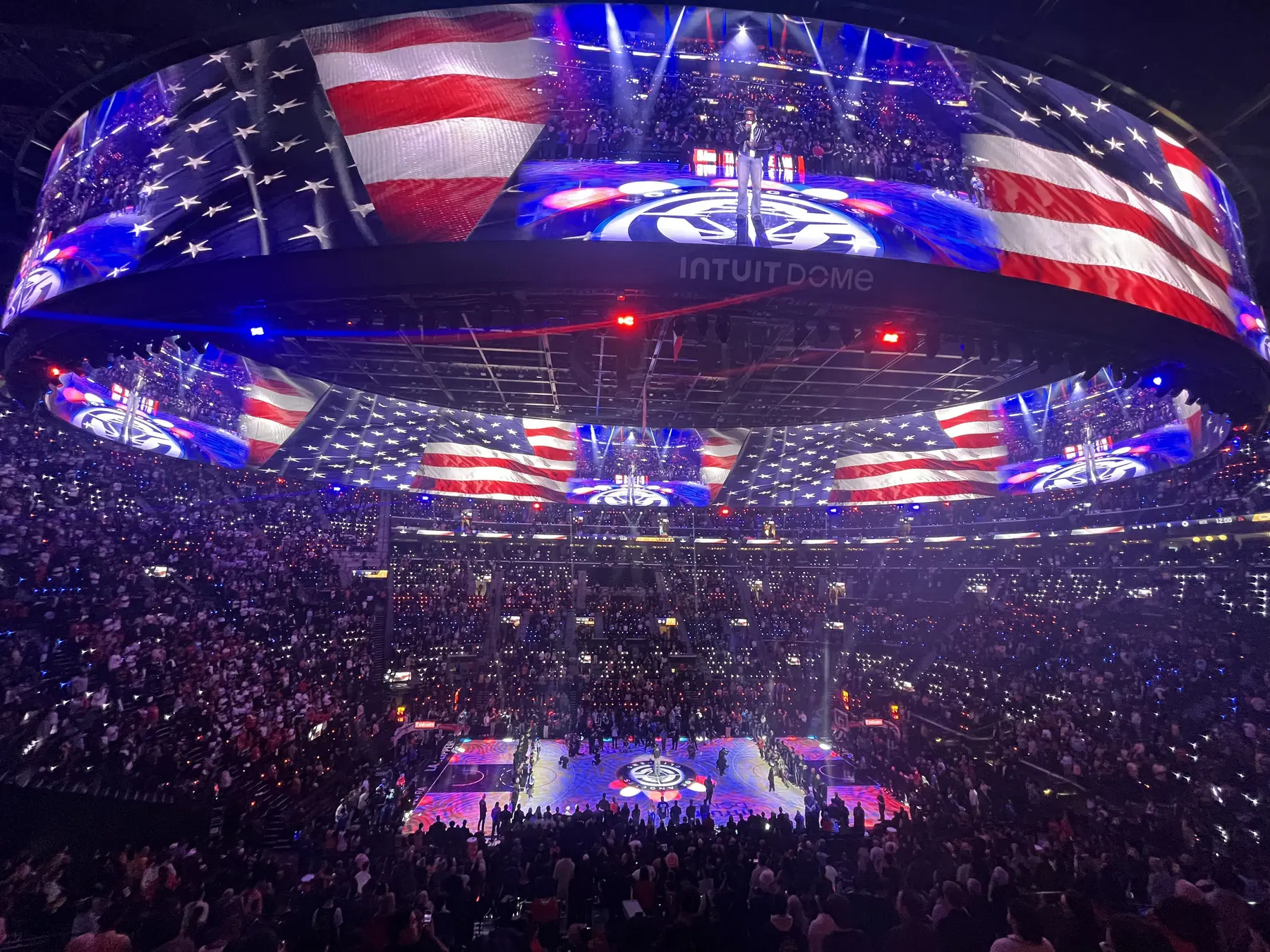 Basketball arena video board during the national anthem
